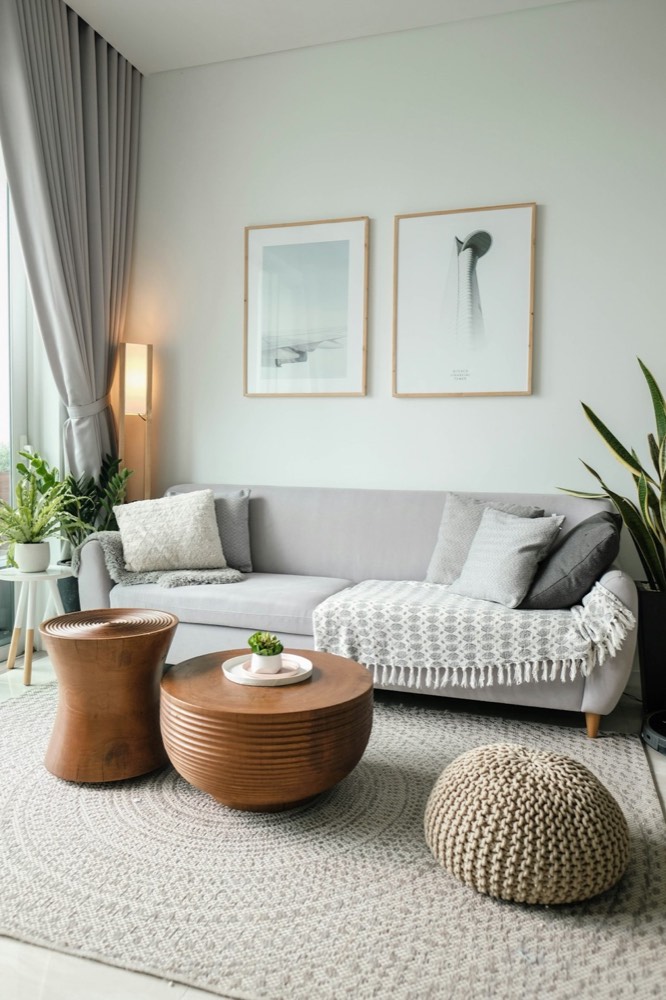 Warm living room with a light sofa and round wooden coffee tables