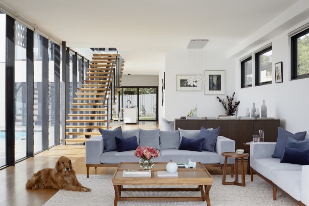 Double height villa living room with a staircase